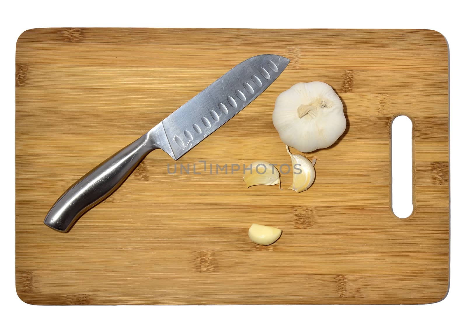 knife and garlic on a cutting board, isolated on white