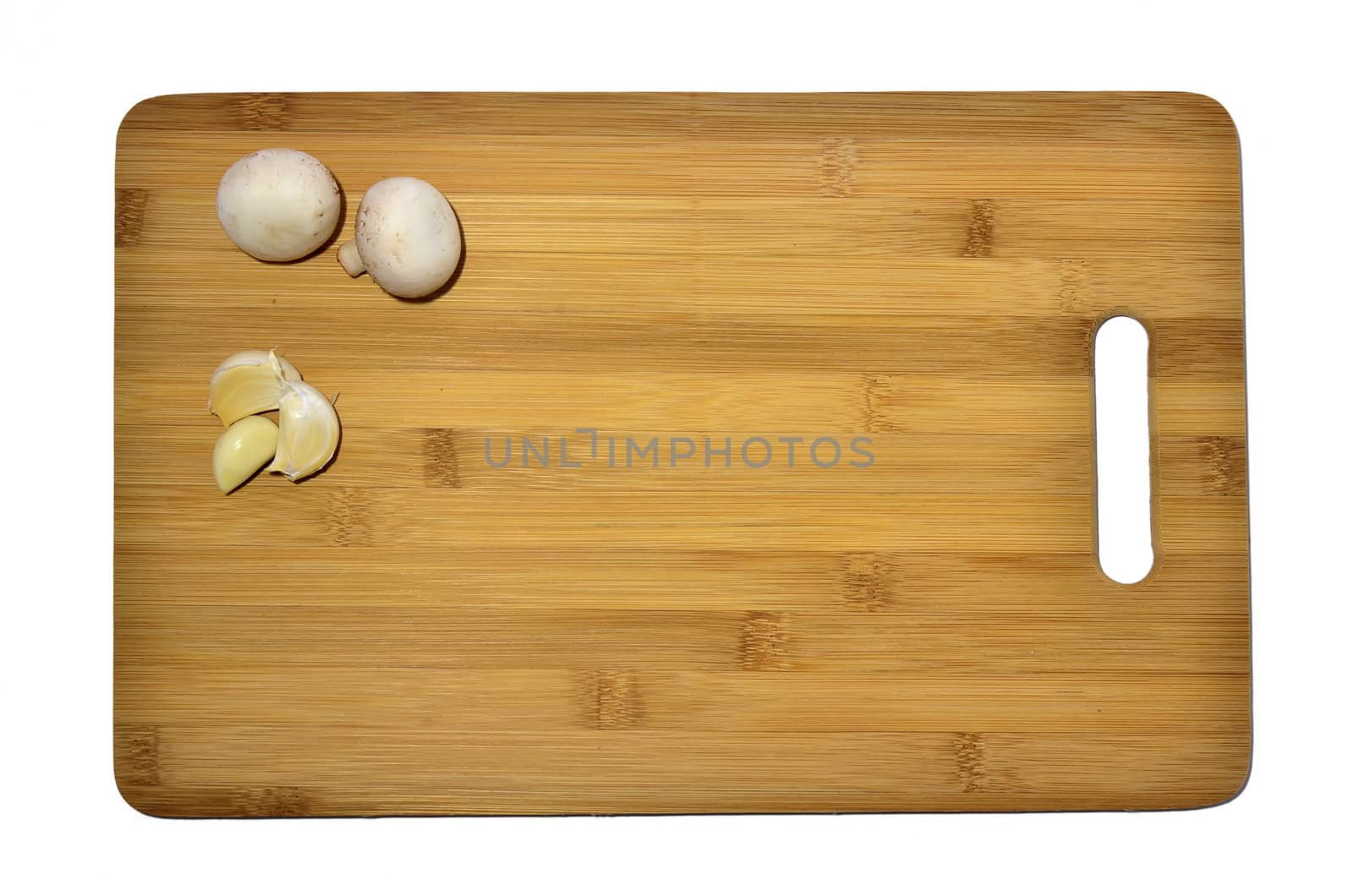 garlic and mushrooms on a cutting board, isolated on white