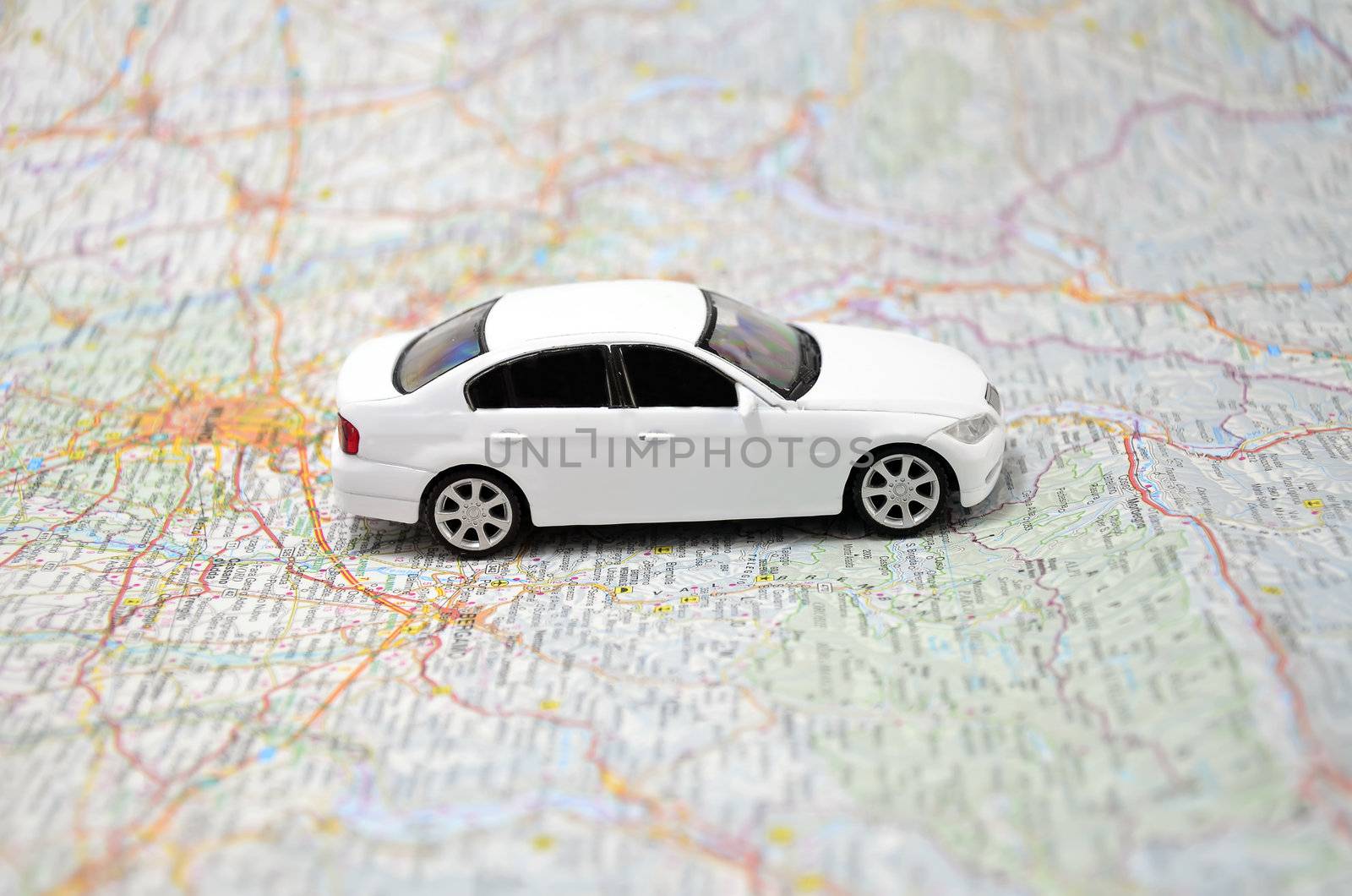 concept small white toy car on italy map