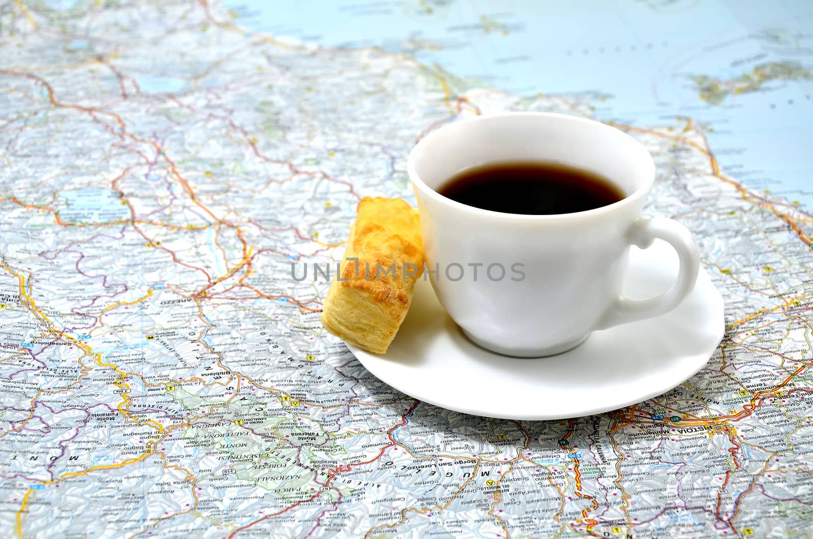 cup of coffee with a snack on the map. concept