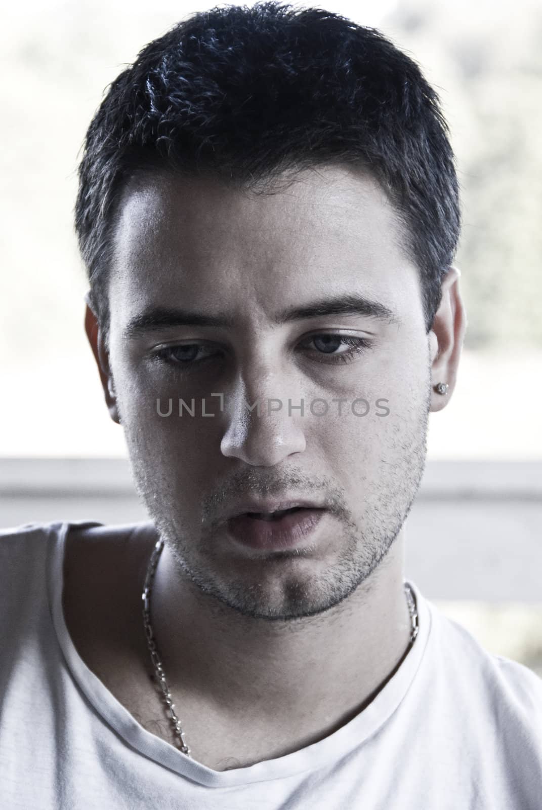 Young men watching something with very serious look.