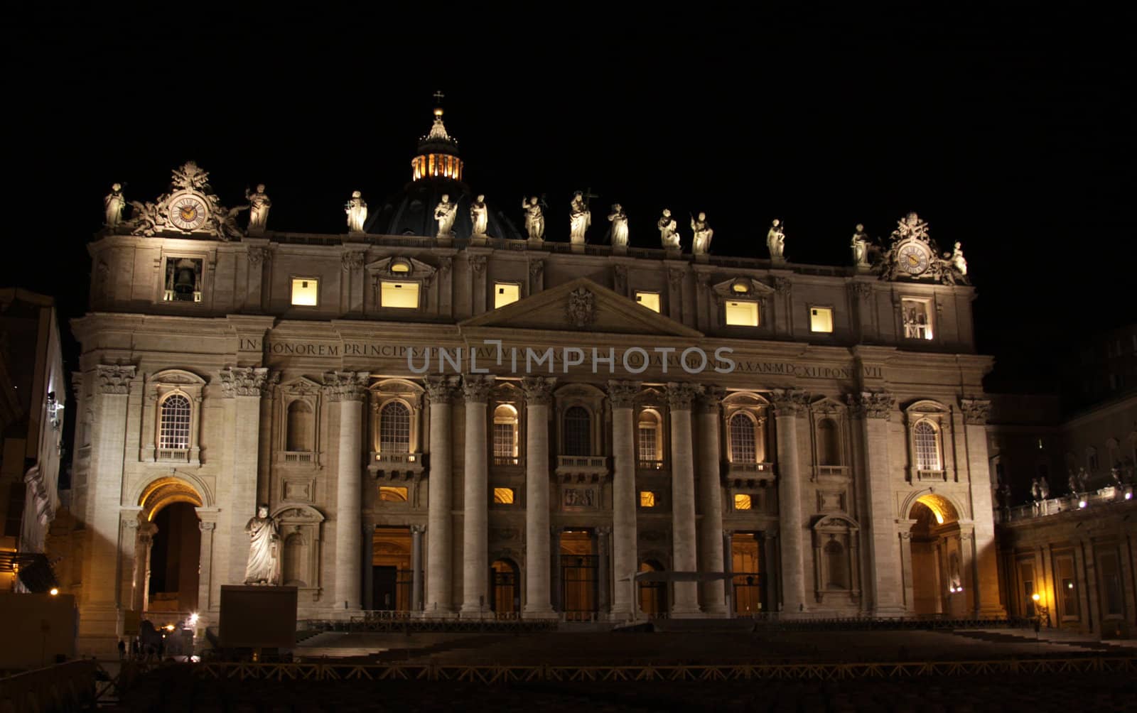 The front of St. Peter's Basilica, in Vatican city at night.
