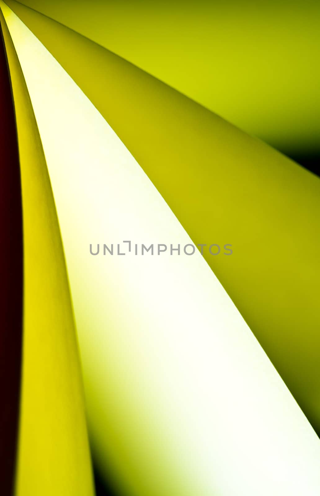 Yellow notepad paper illuminated by LED light with black background in portrait orientation