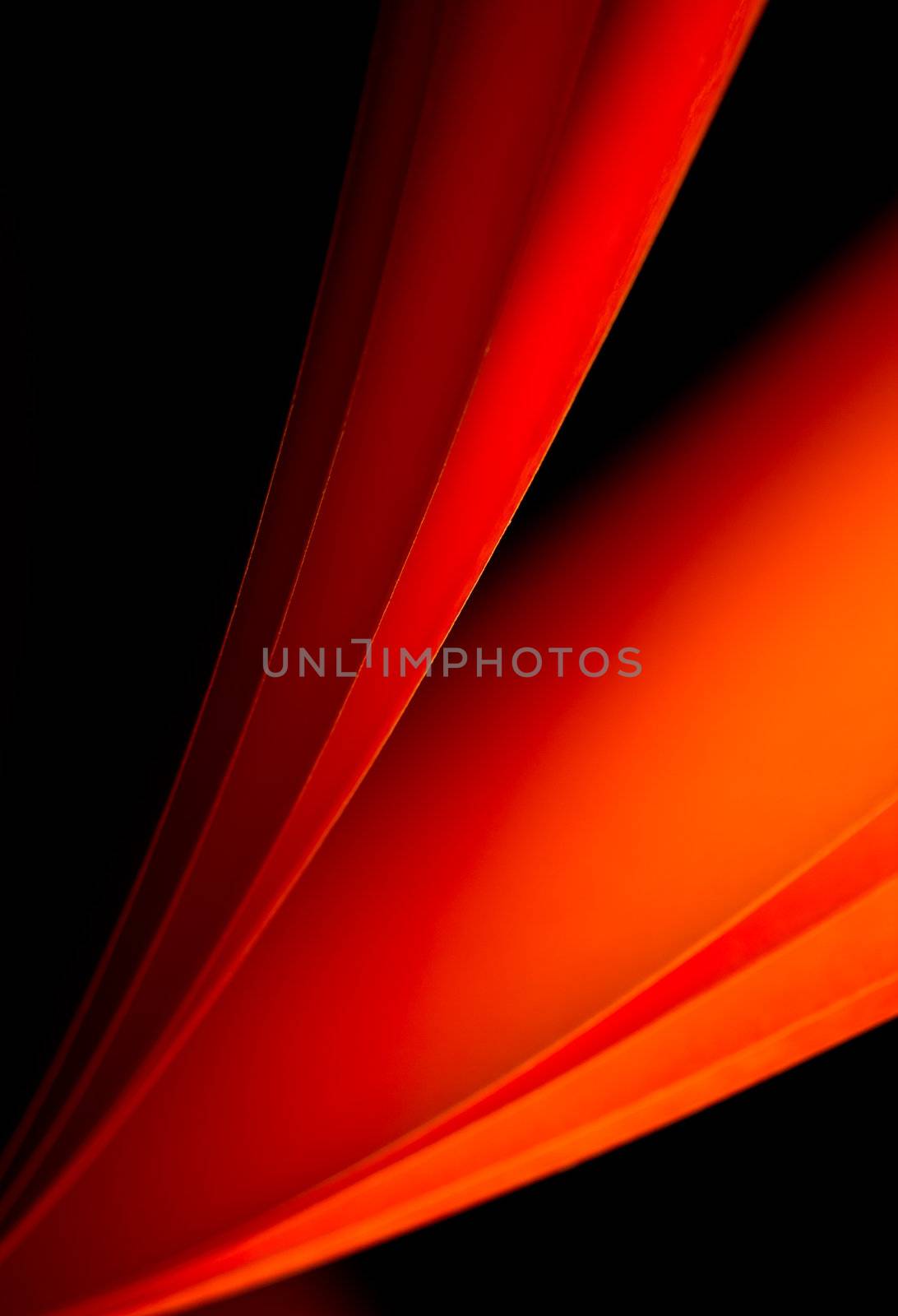 Red notepad paper illuminated by LED lights portrait orientation on black background