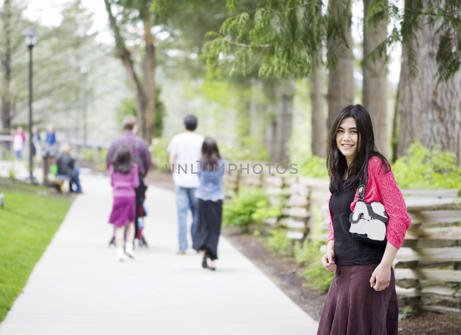 Young teen or woman out on walk with family