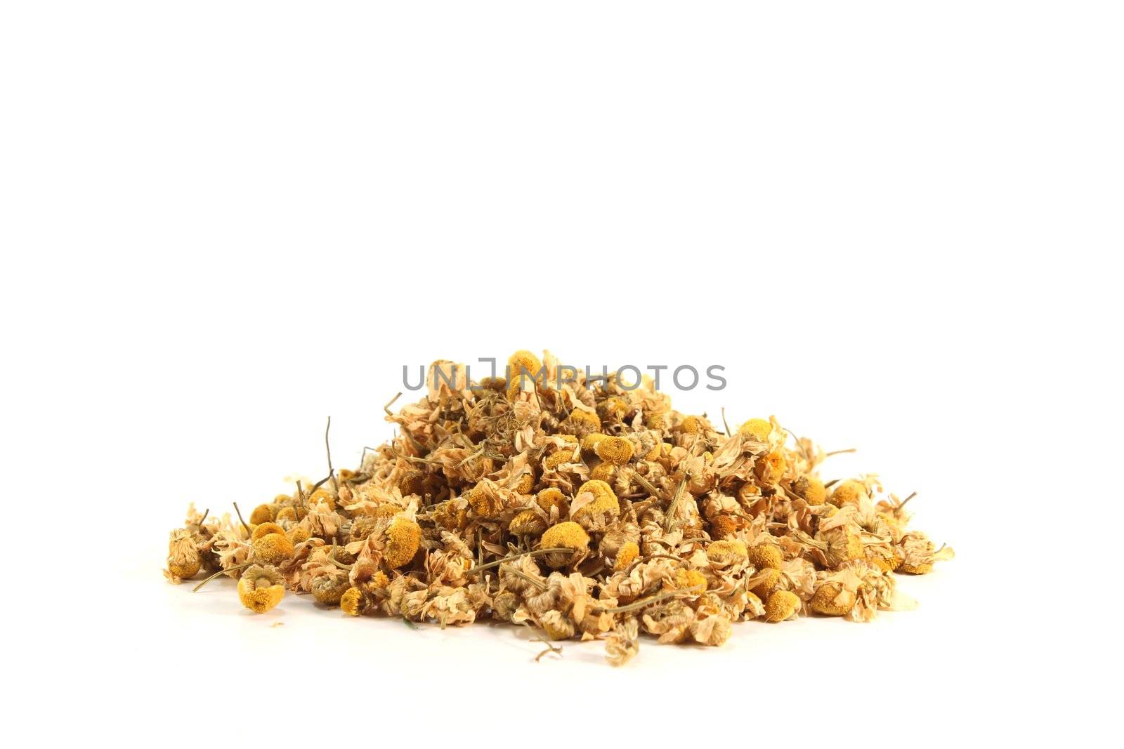 dried yellow chamomile flowers on a white background