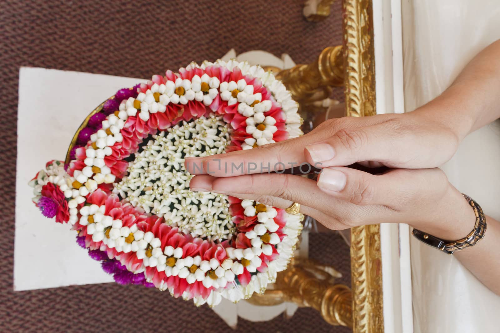  Hand of bride wait for blessed water at Thai wedding ceremony in Thailand