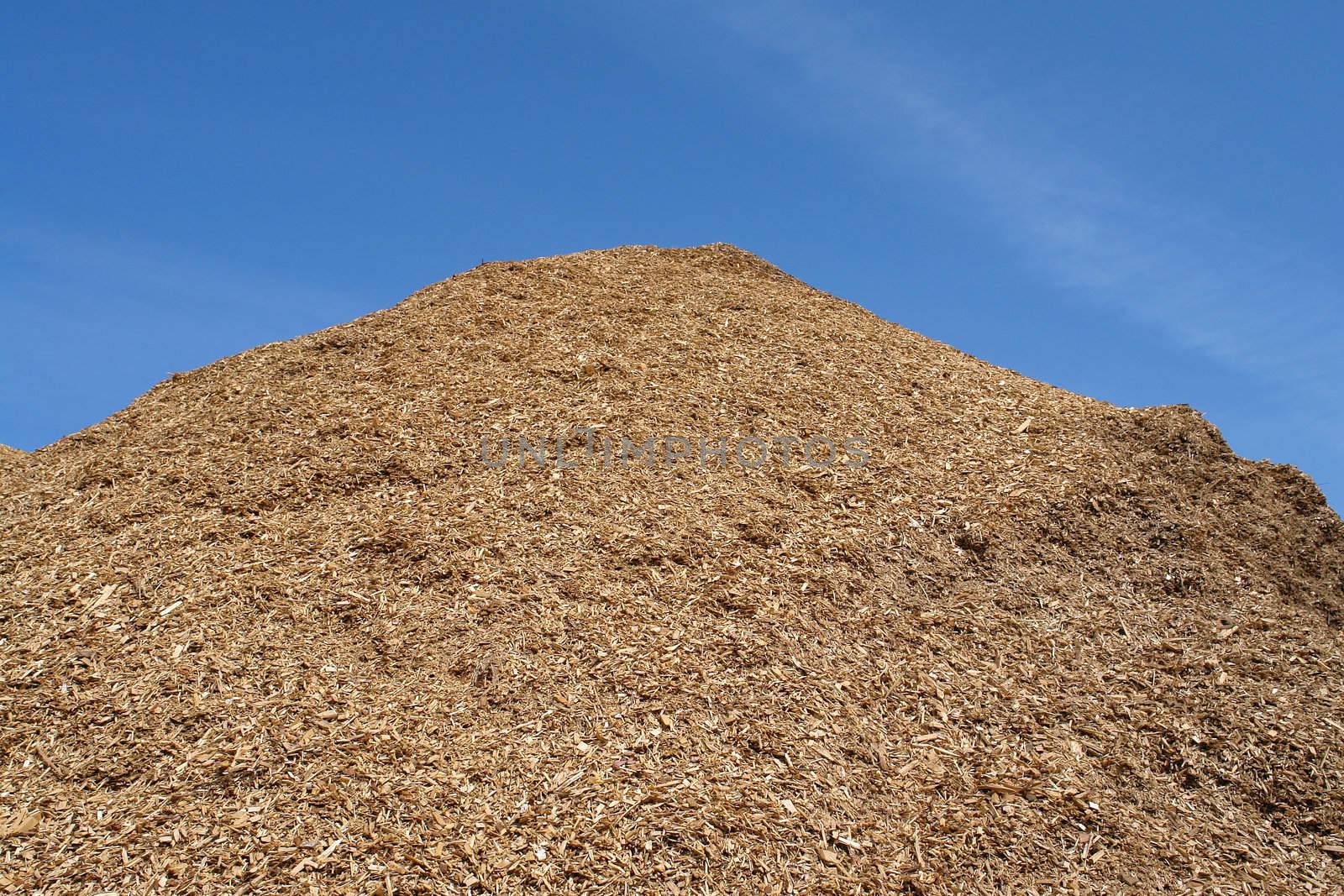 Pile of wood chips mulch for gardening and heating background