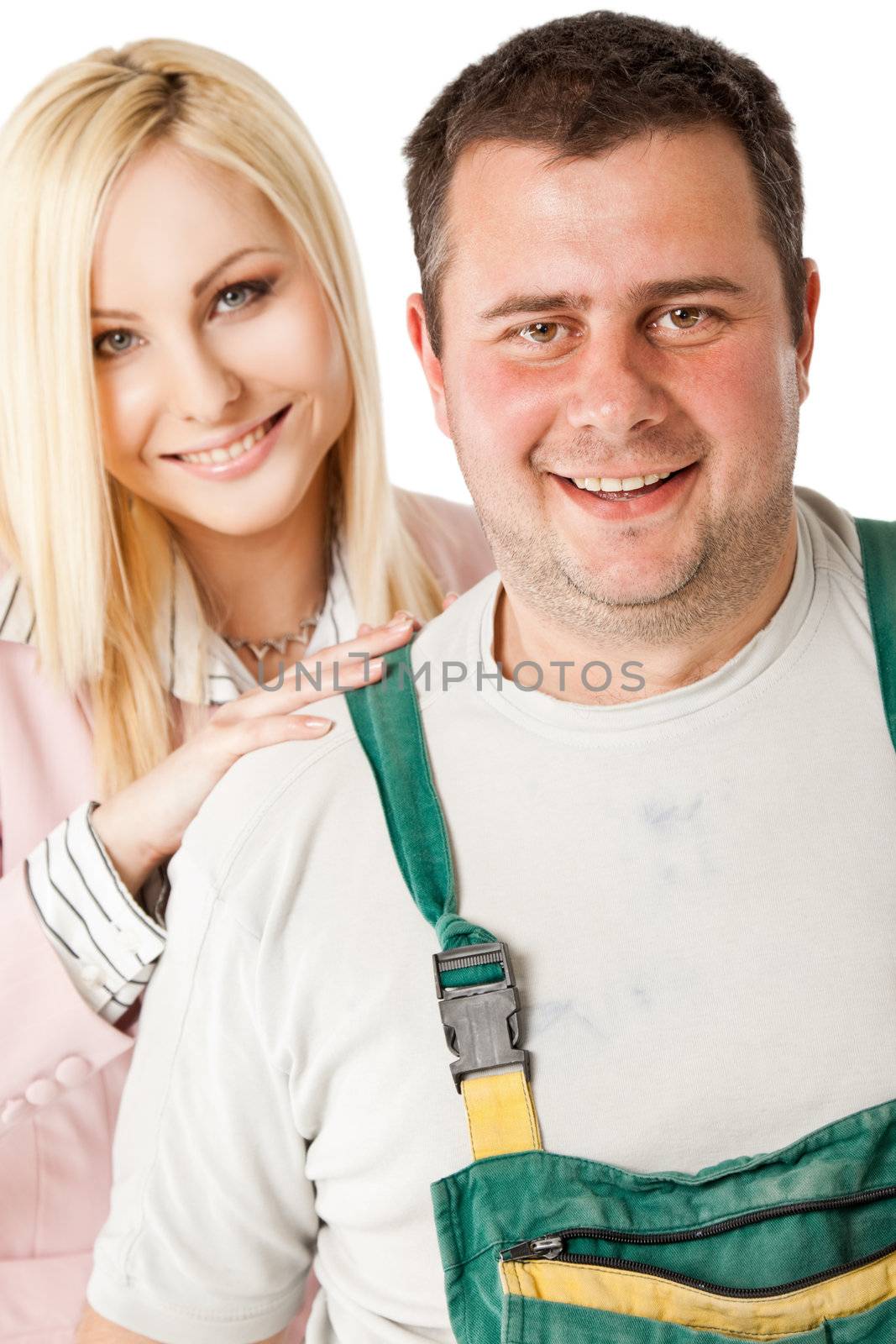 Blonde businesswoman and male construction worker smiling at camera