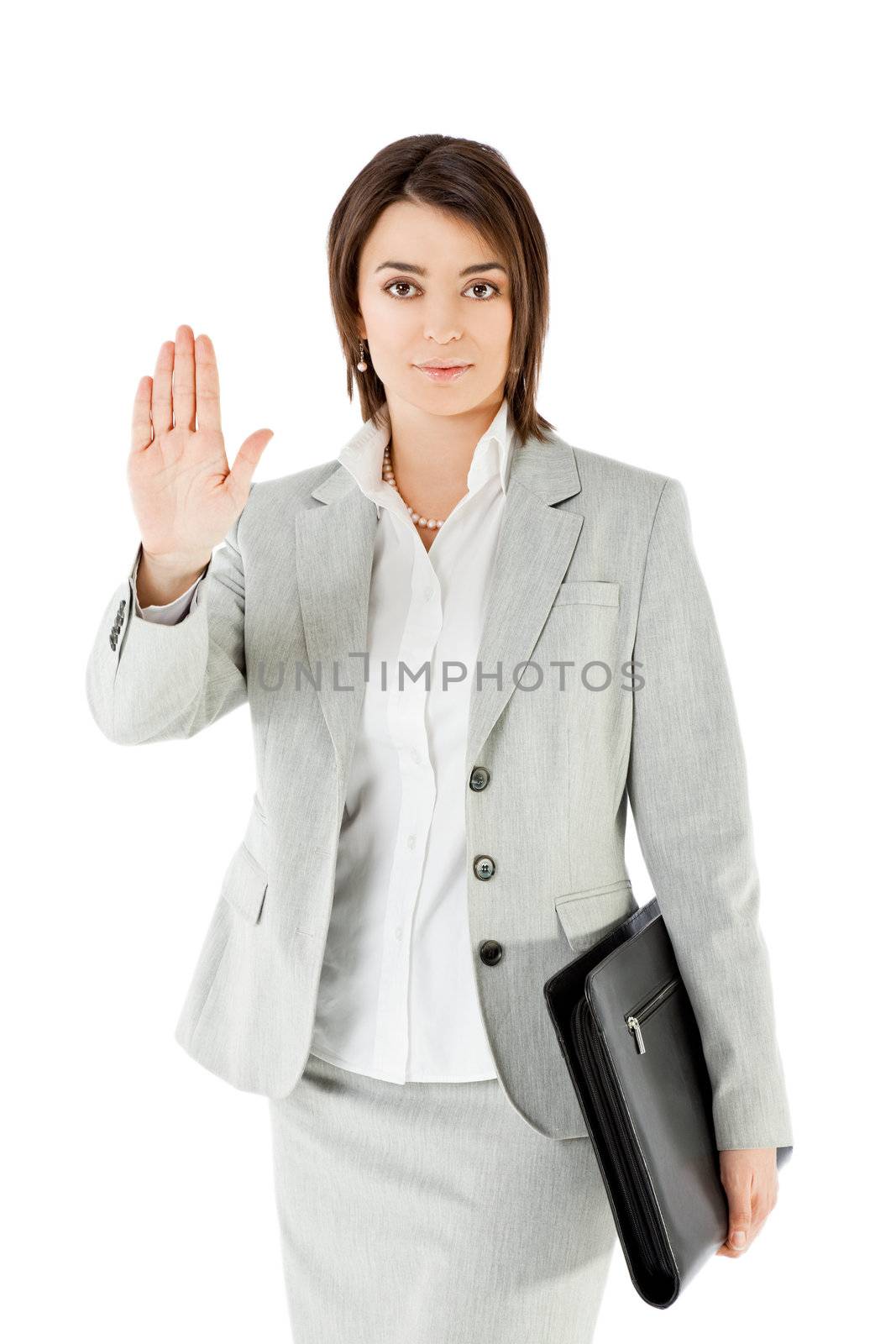 Businesswoman standing on white background, showing stop sign with hand