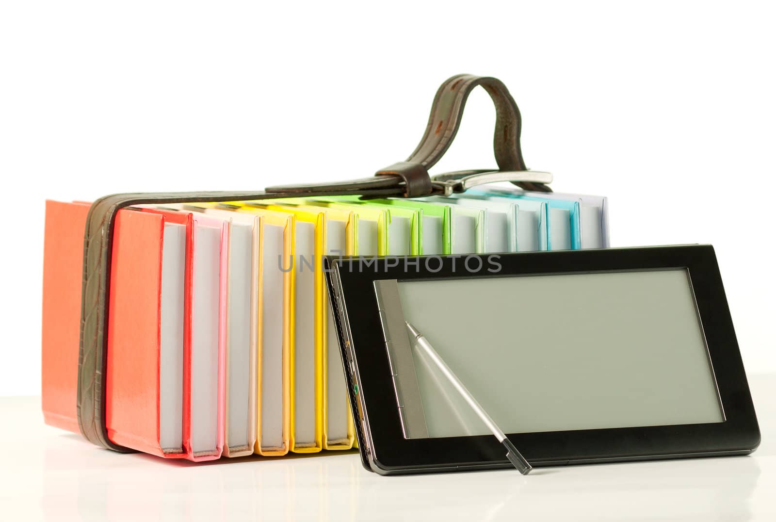 Stack of colorful books and electronic book reader on the white background by AndreyKr