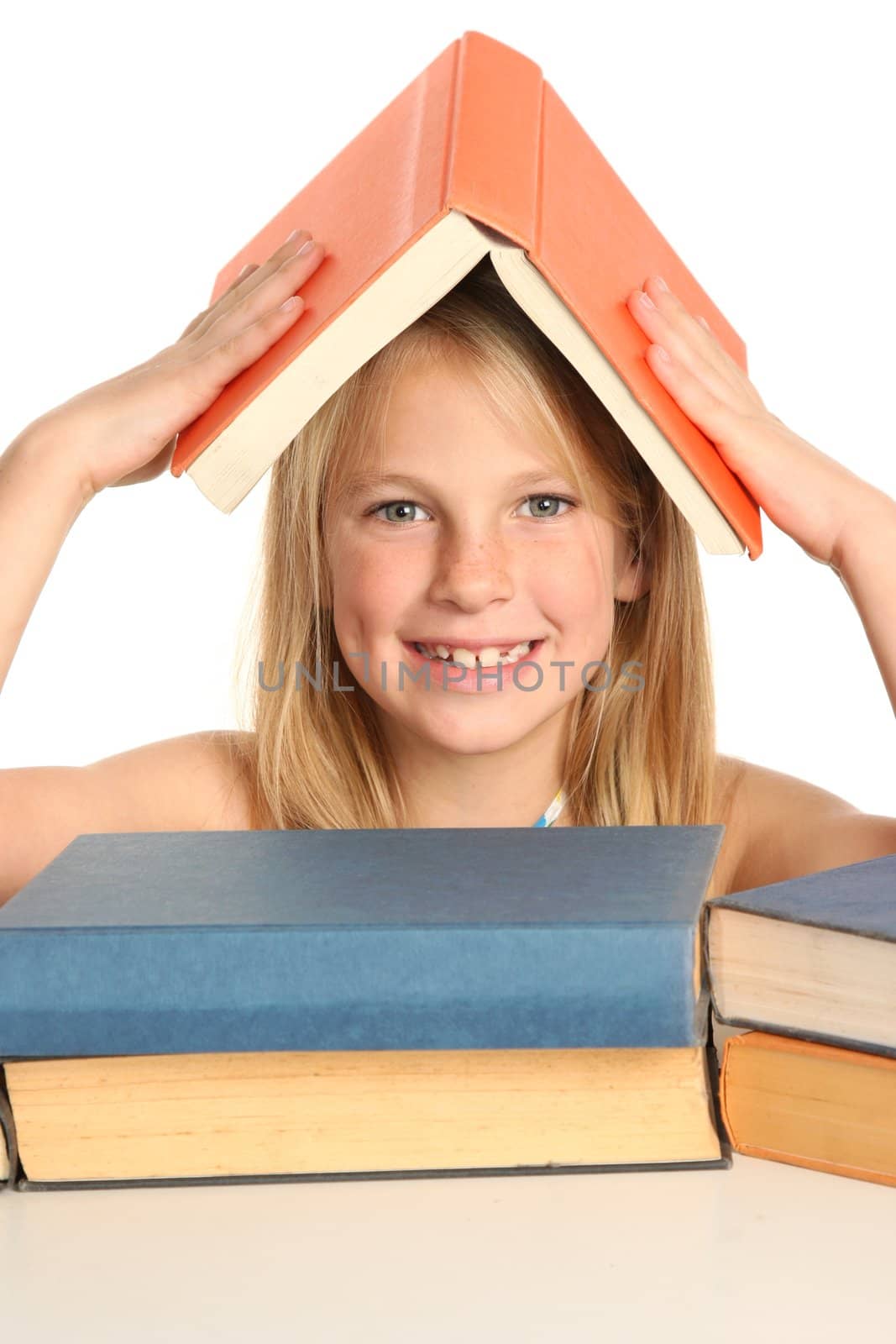 Pretty young school girl with books on her head