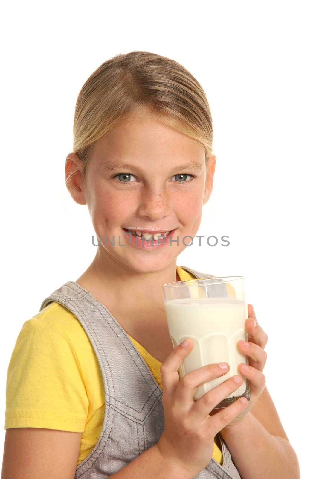 Cute young girl with glass of fresh milk and milk on her top lip