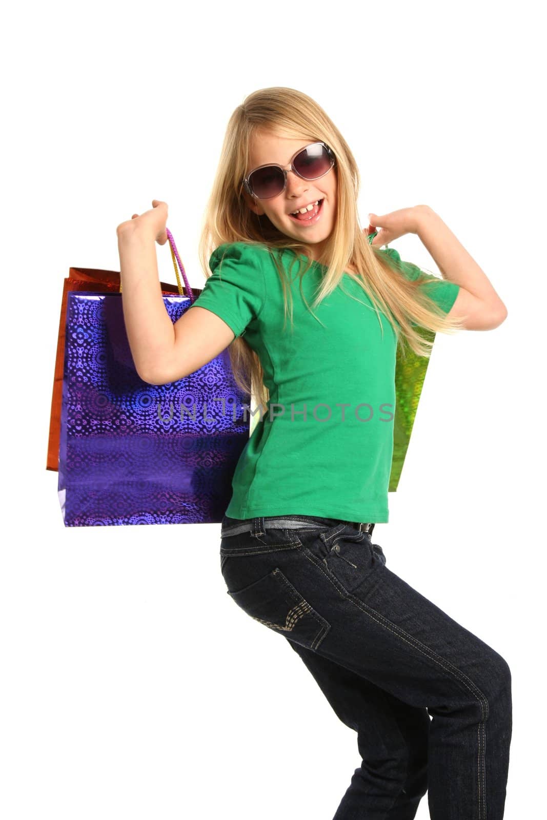 Trendy young shopping girl with bags and sunglasses