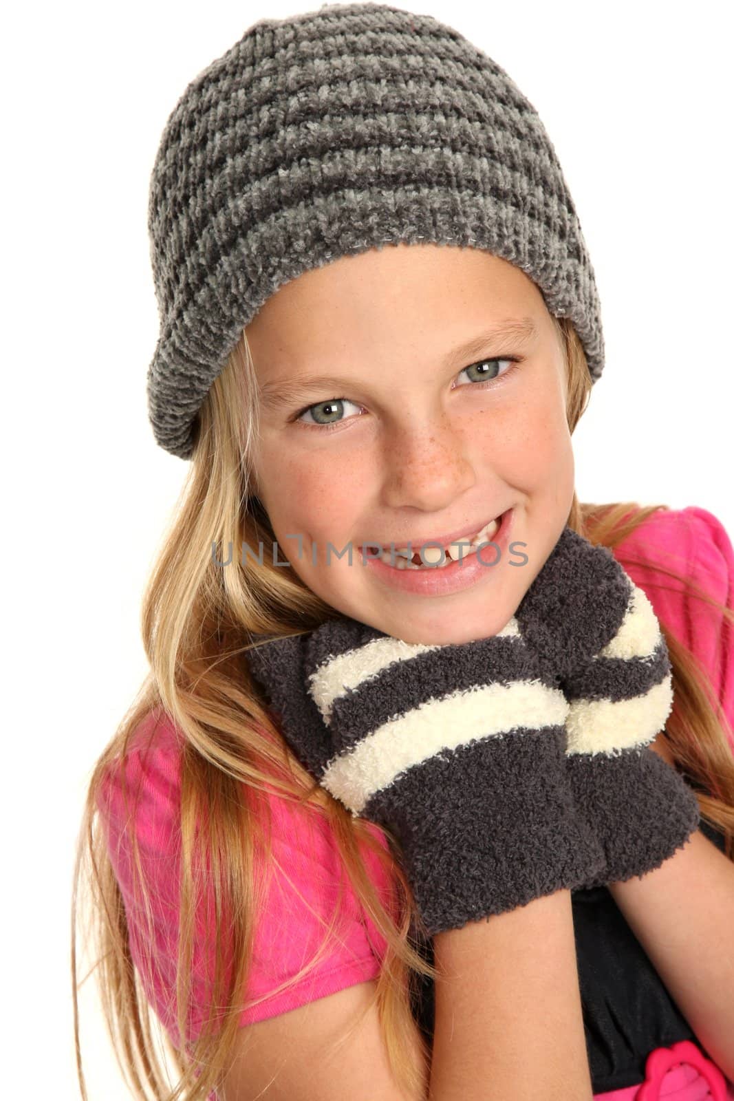 Lovely young girl kid in woolen hat and mittens
