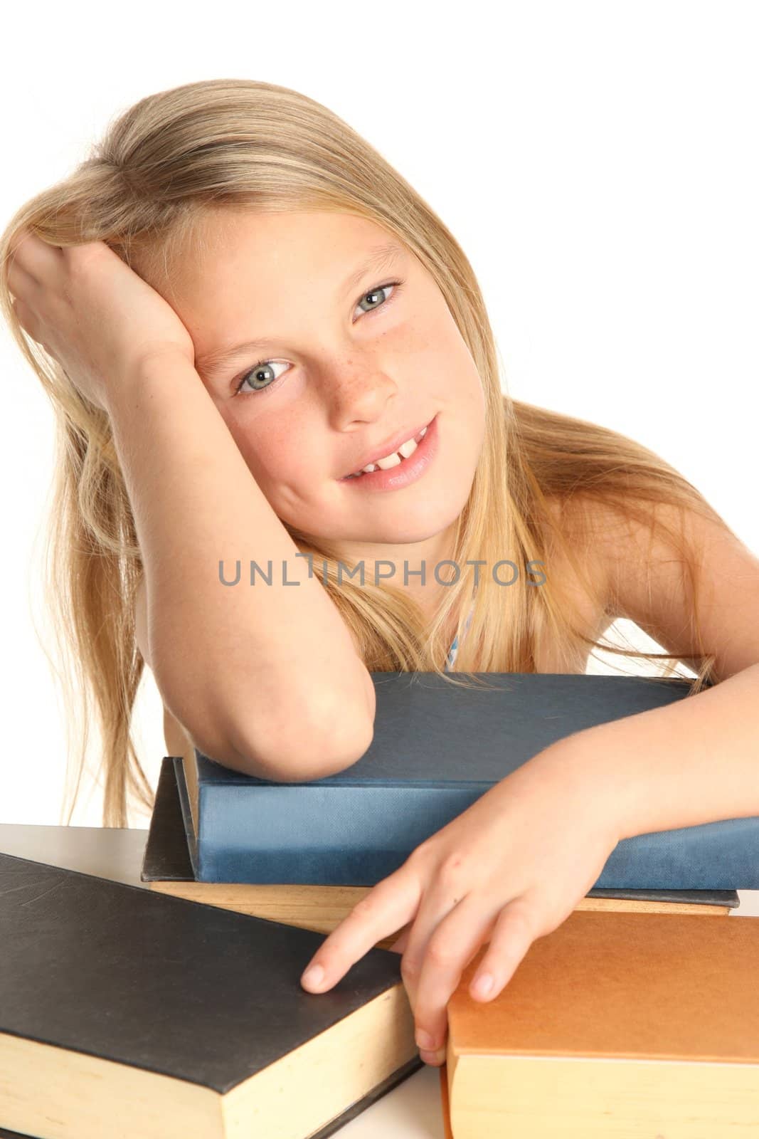 Pretty young school girl and a pile of books to read