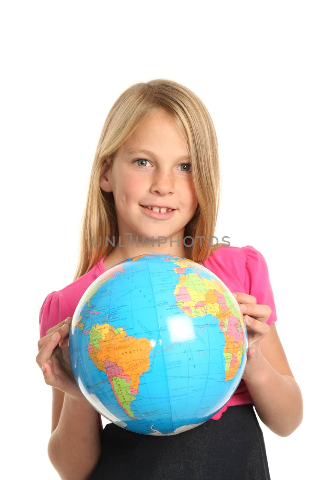 Cute and confident young preteen girl holding the world globe in her fingers