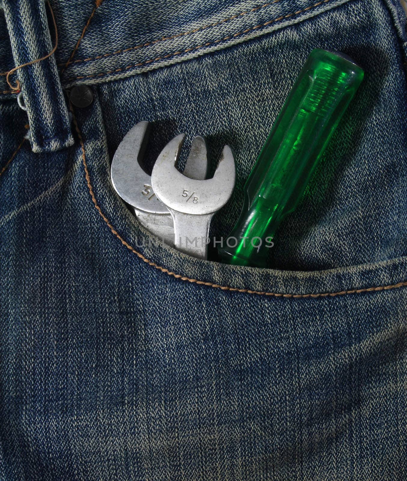 Blue jean pocket with spanners and screwdriver