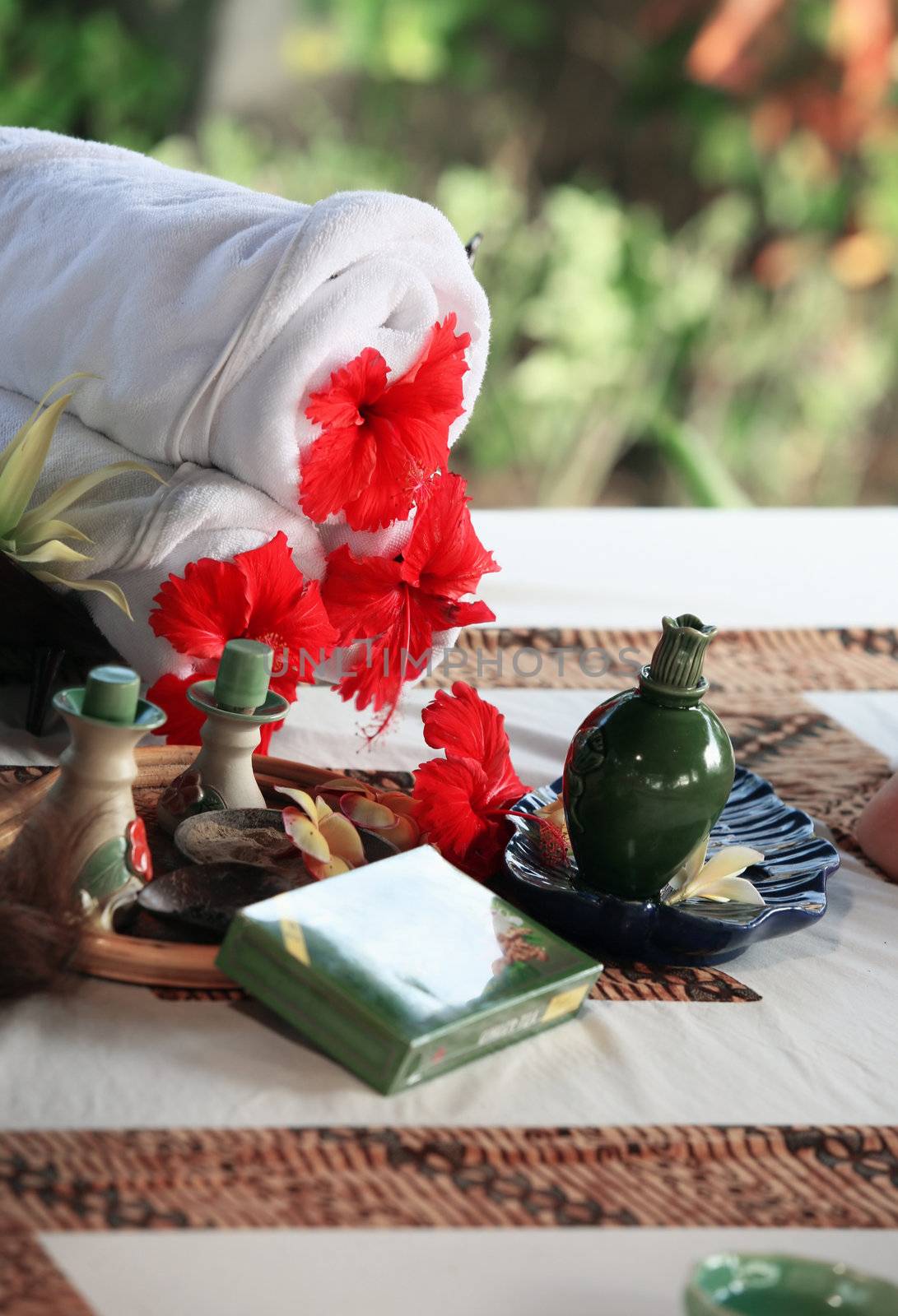 White rolled up towel with red flowers