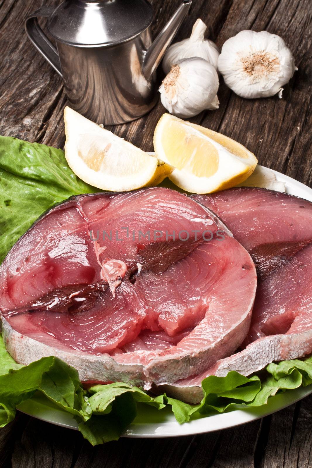 two slices of raw swordfish with lemon