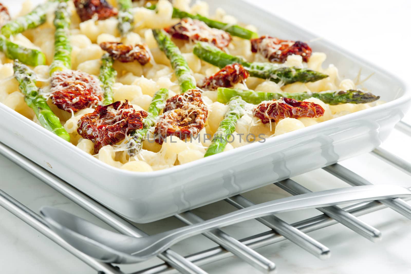 pasta baked with dried tomatoes, asparagus and pecorino cheese