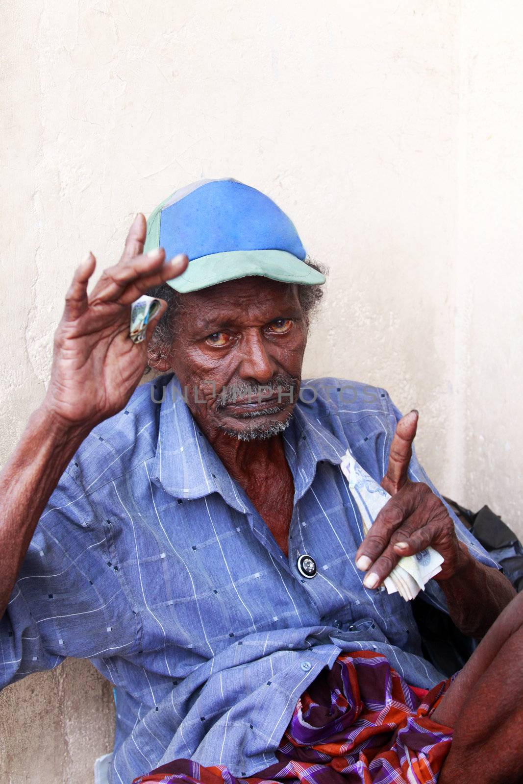 KALATURA, SRI LANKA 09 APRIL 2011: Drunk old the beggar in the street city Kalatura 9 April 2011 on Sri Lanka