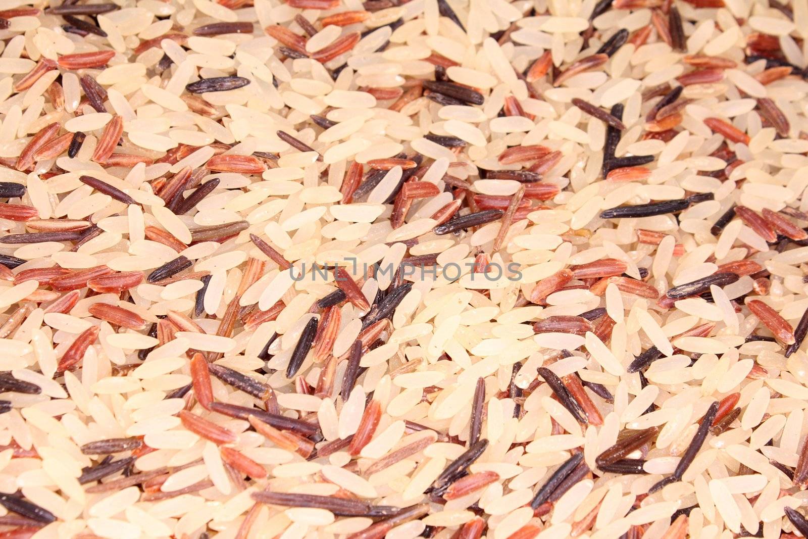 a handful of colorful rice grains as a background image