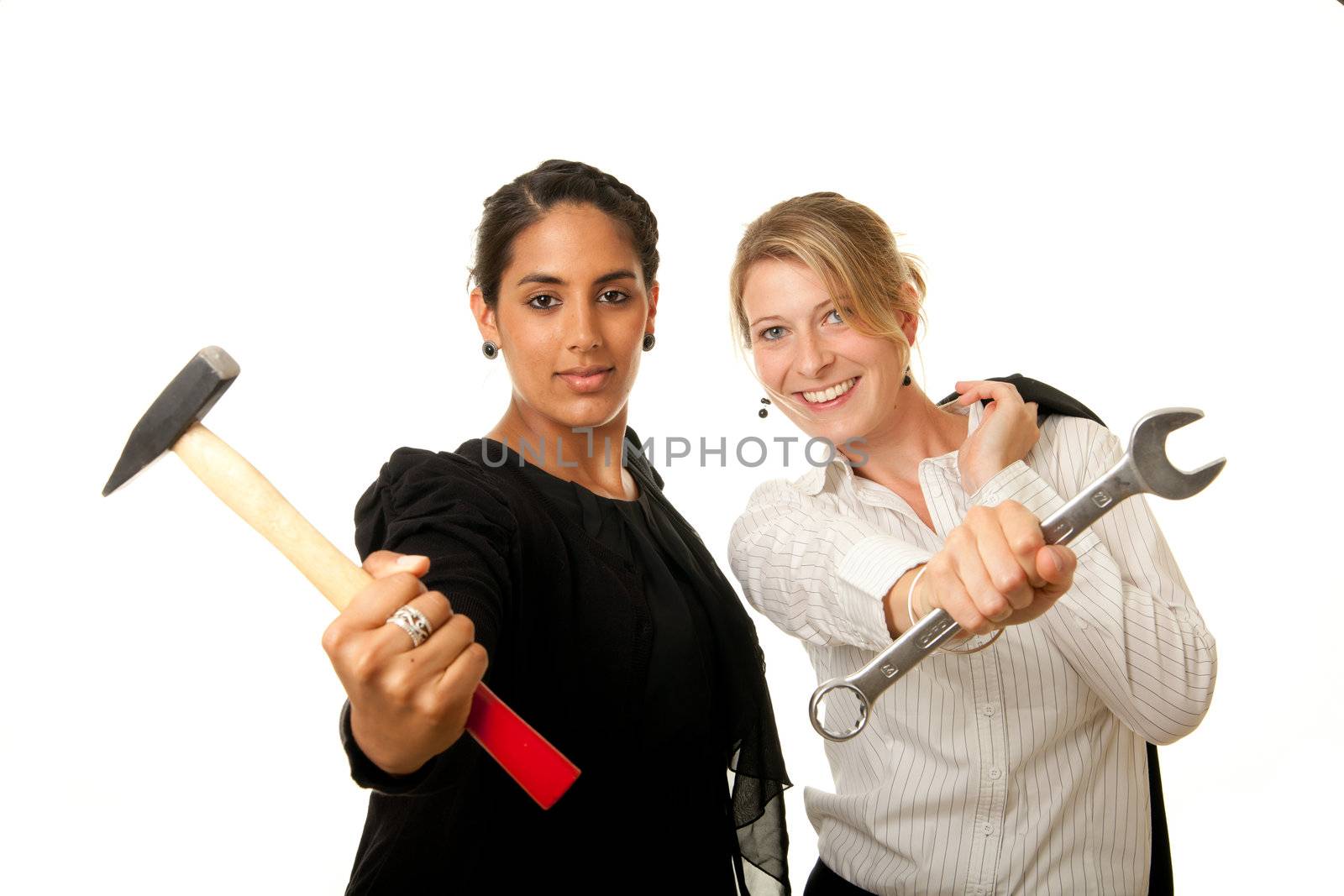 two young businesswoman showing hammer and wrench as tools