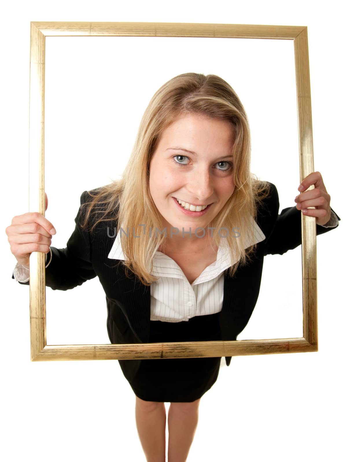 a wide-angle shot of a young businesswoman looking through a pictureframe