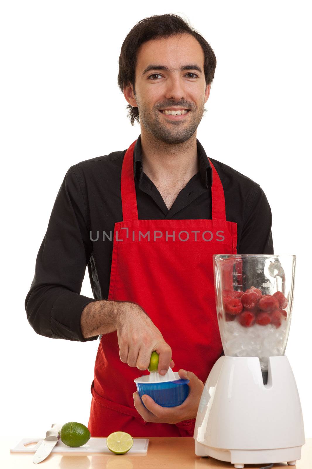 a chef squeezing a lime with a juicer