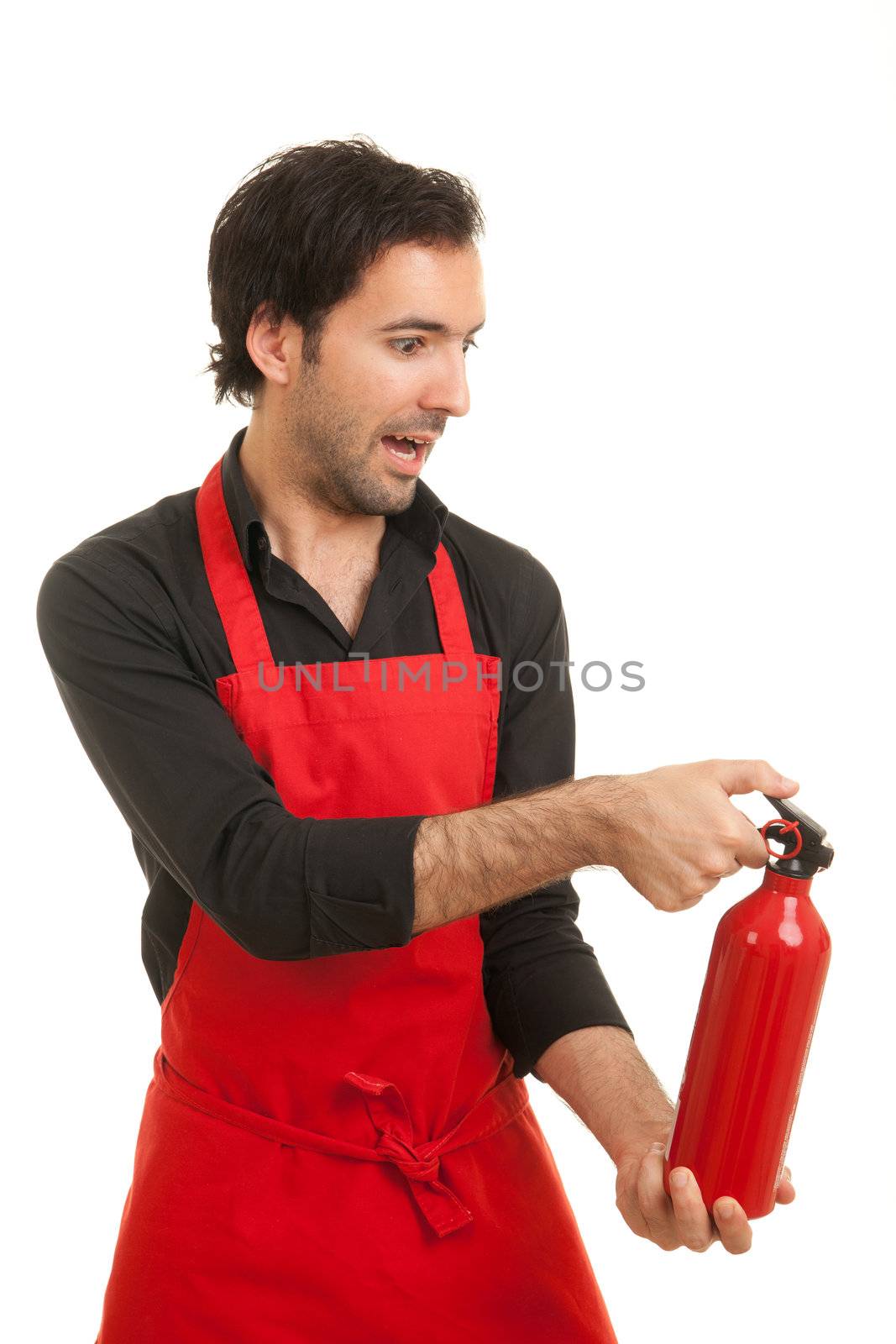 a profile shot of a scared looking chef with a fire extinguisher