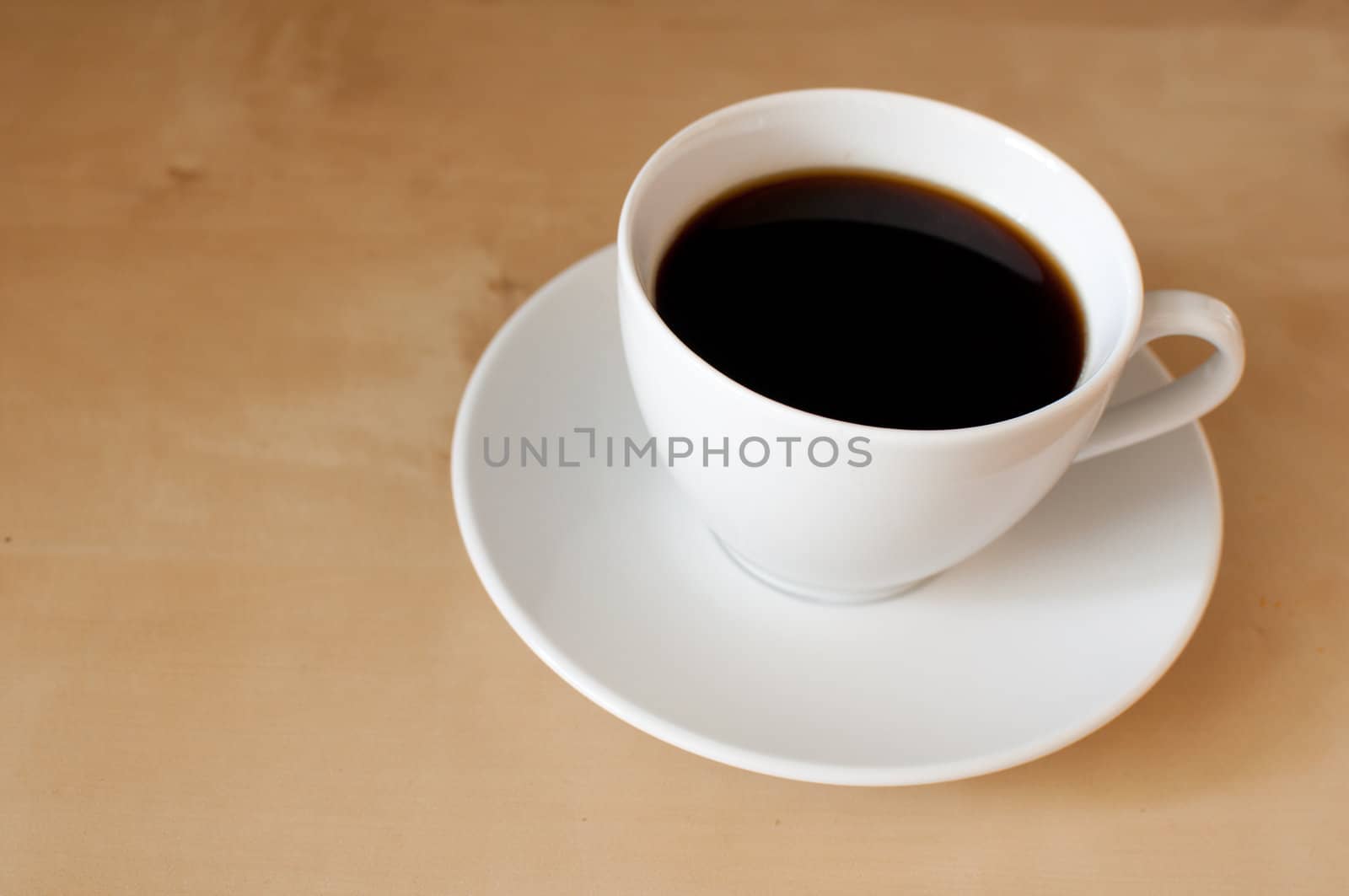 Espresso coffee in white mug on wooden table