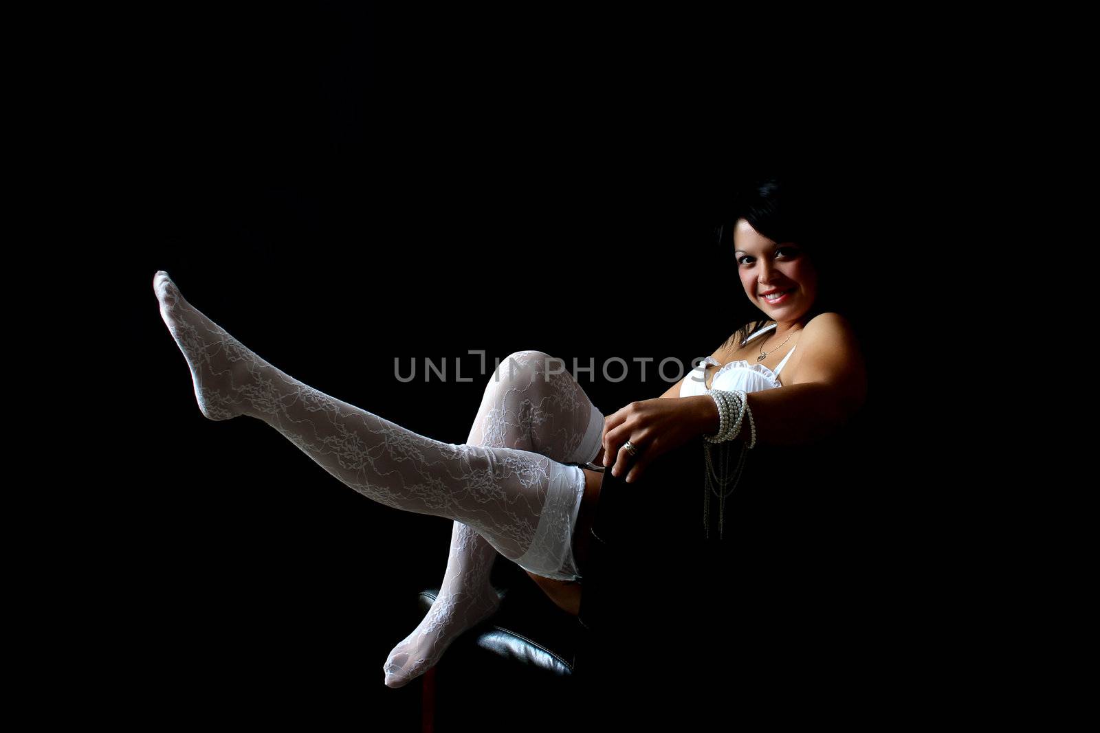 Beautiful brunette female in lingerie against black