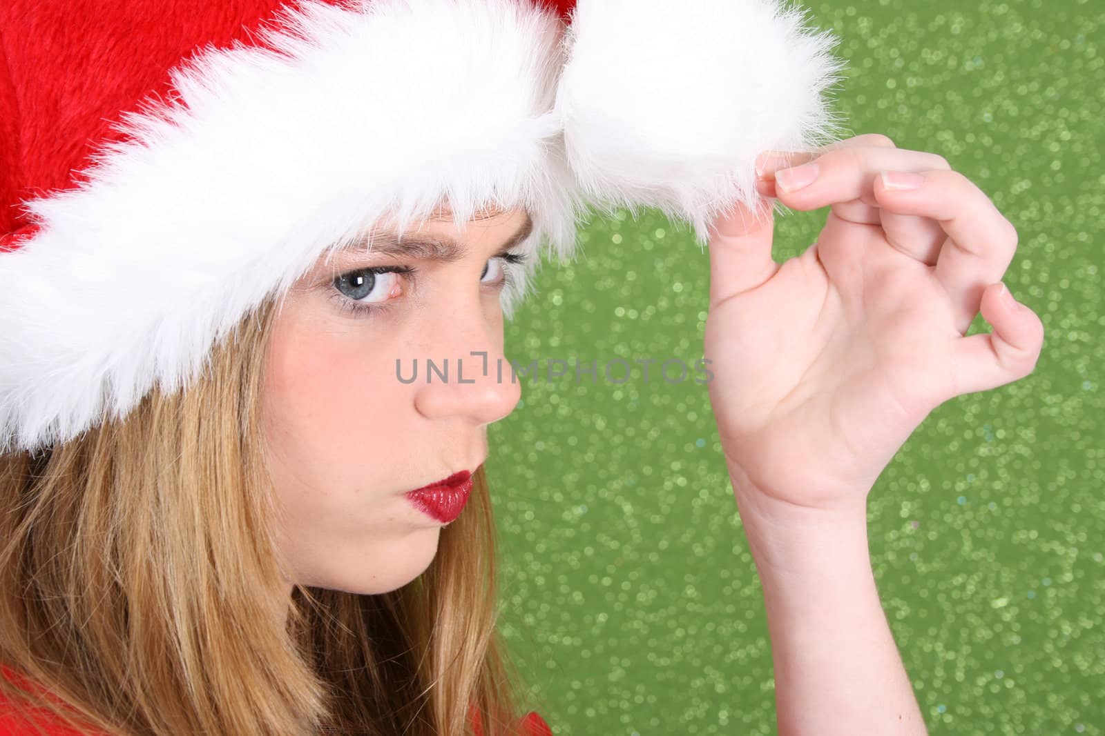 Teenager with red lips wearing a christmas hat