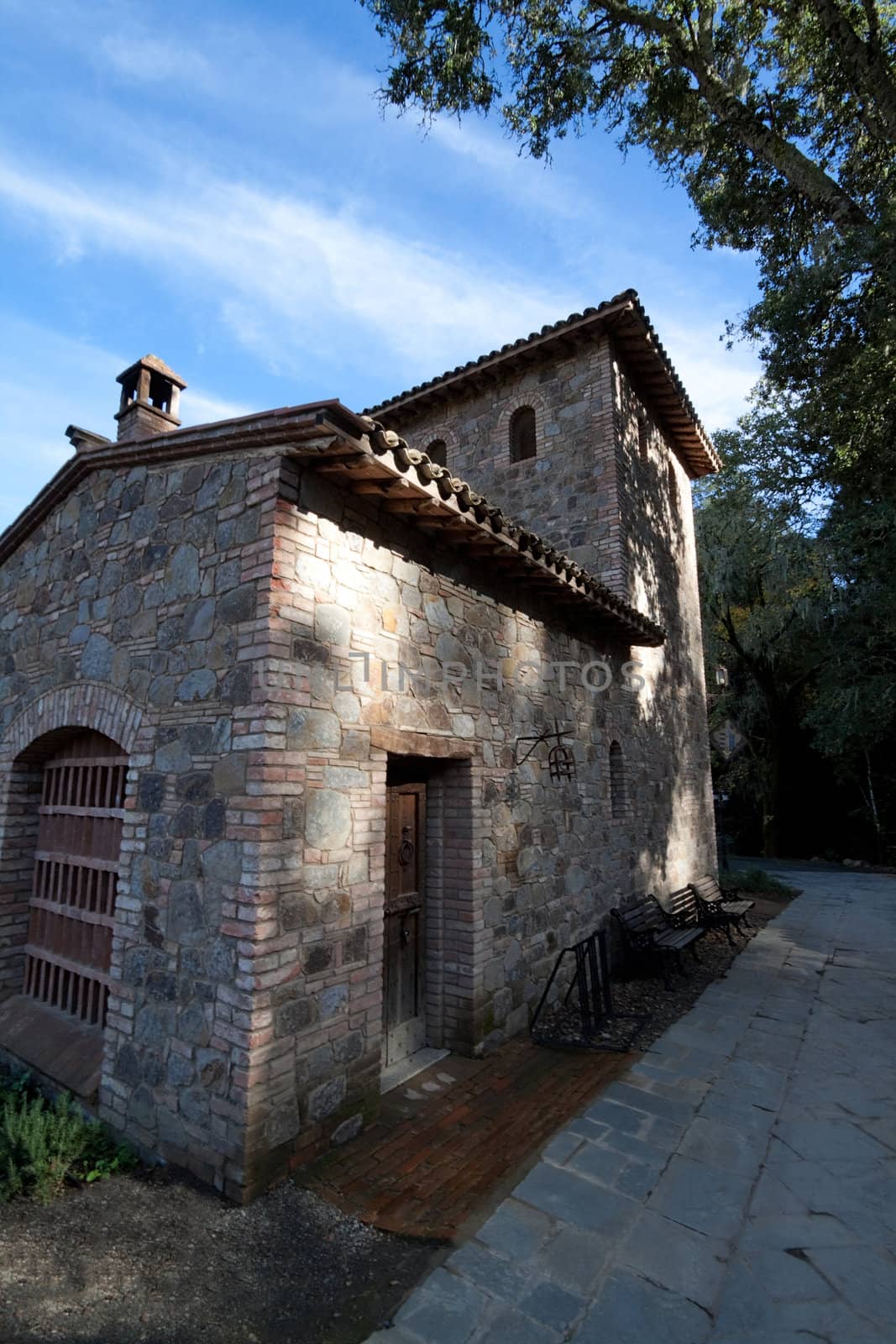 An old stone house sitting next to a forest