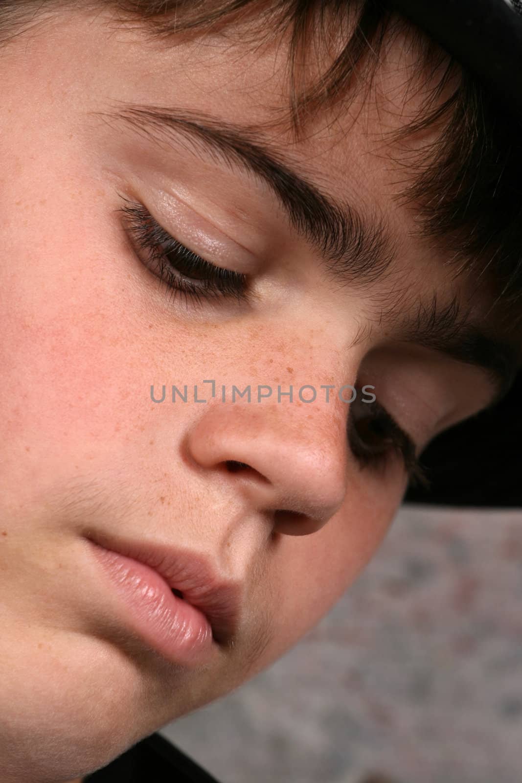 Serious teenage boy against a brick wall background