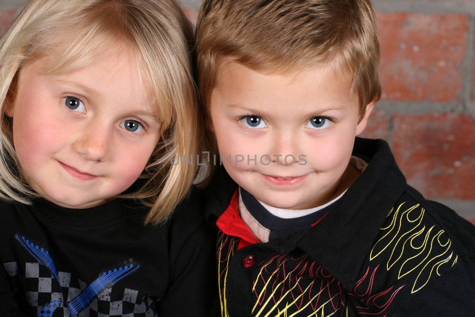 Beautiful young girl with blond hair and her cute boy friend 