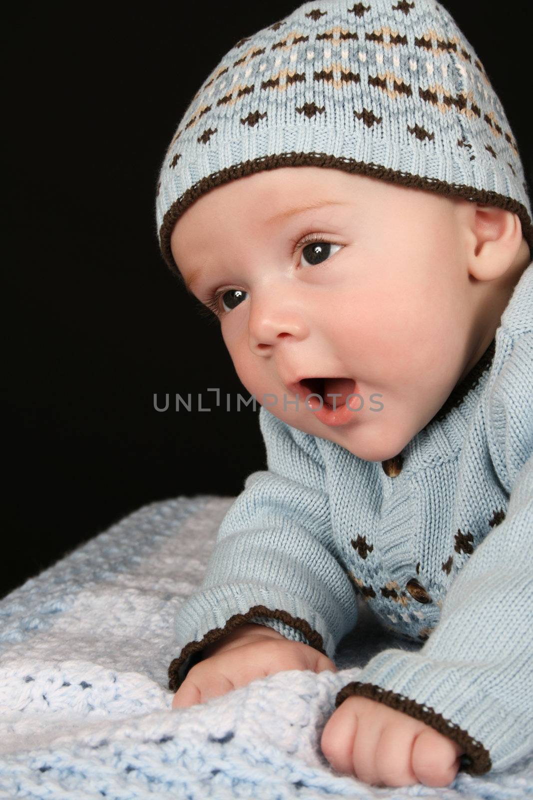 Cute four month old baby boy lying on his tummy