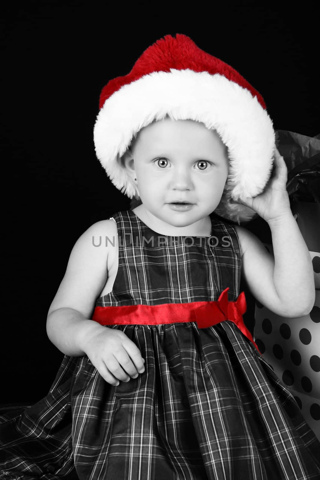 Cute caucasian toddler wearing a fluffy christmas hat