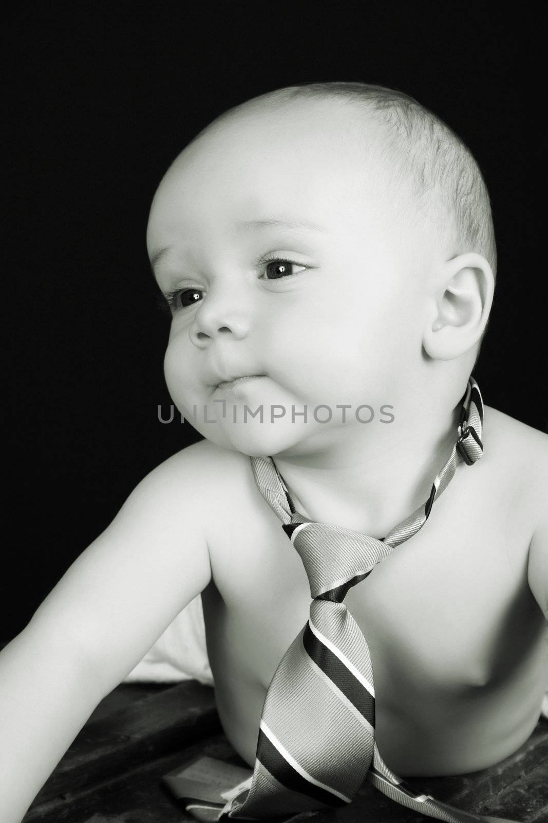 Cute caucasian baby wearing just a tie and diaper