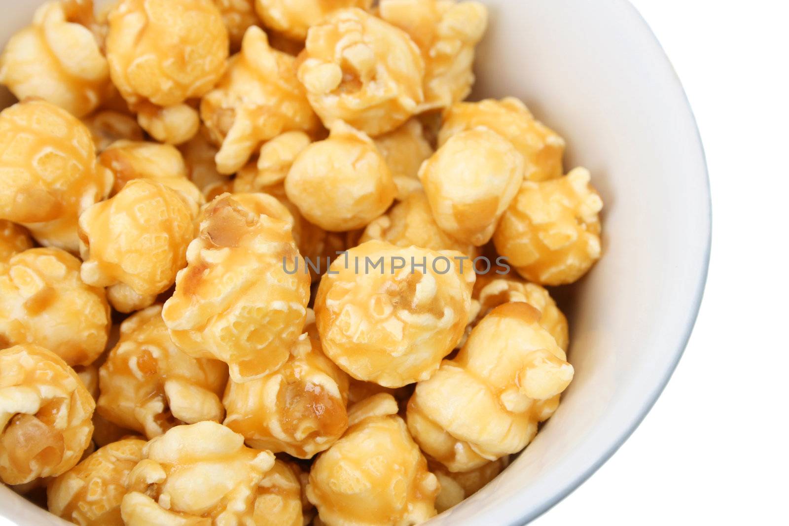 A white ceramic bowl filled with caramel popcorn