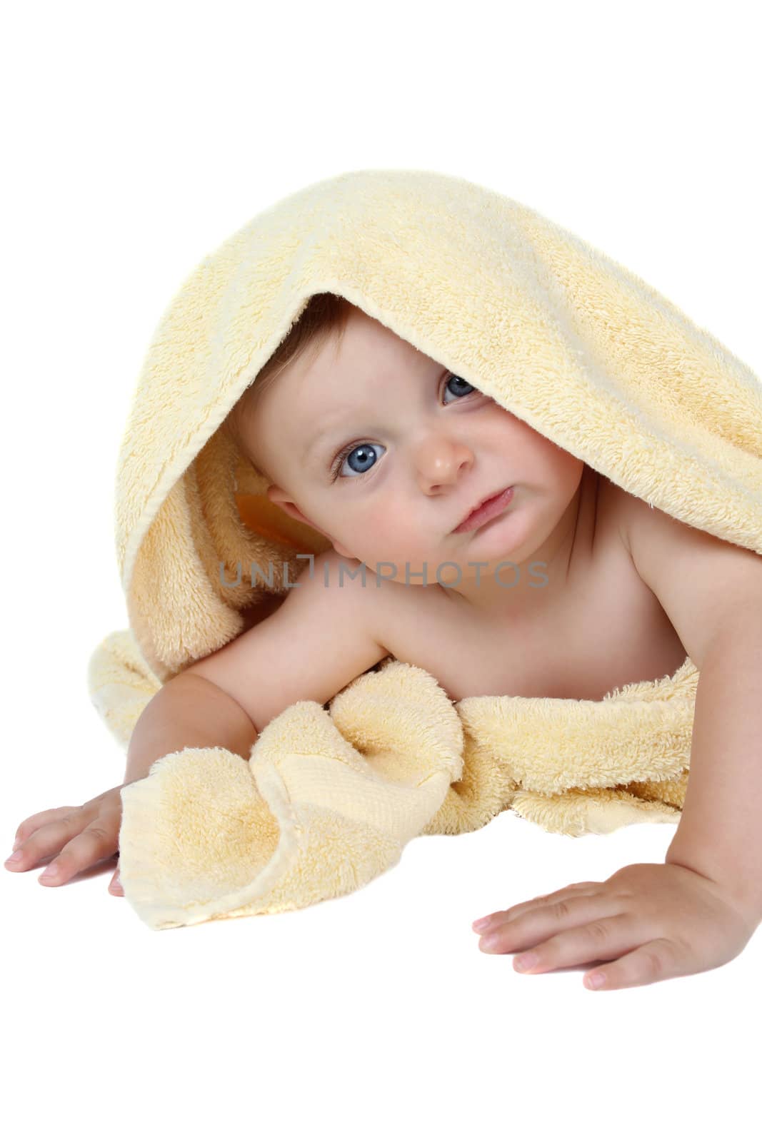 Beautiful baby boy wrapped in a soft yellow towel