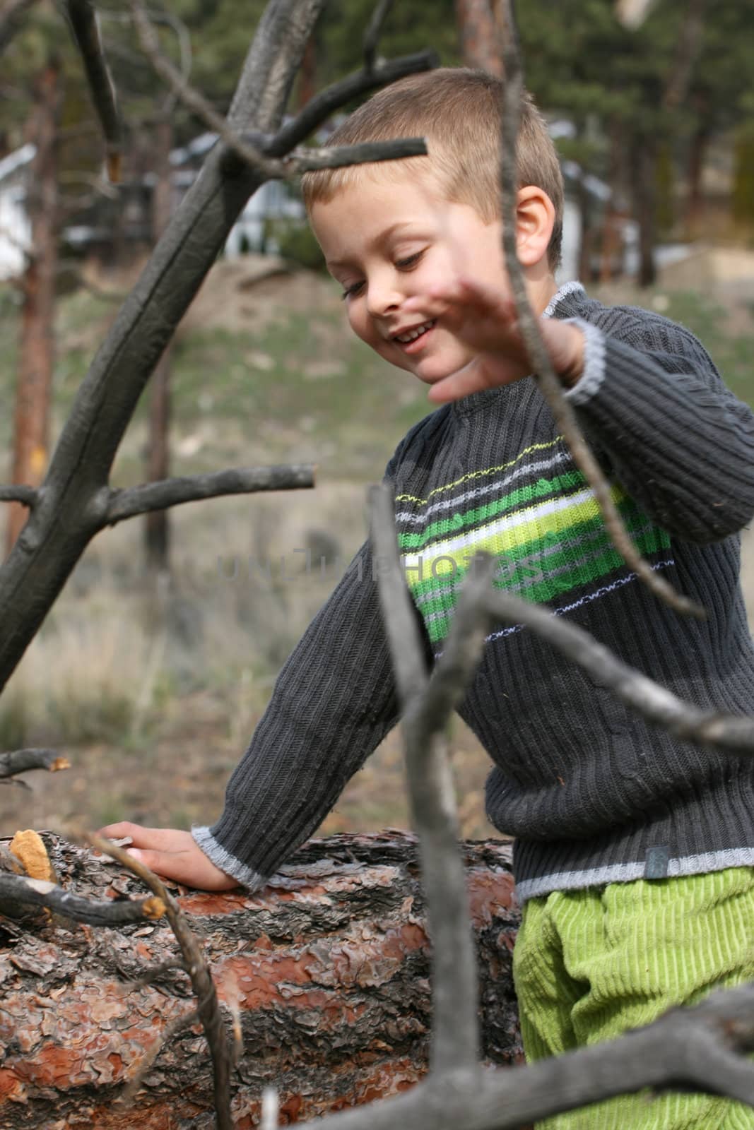 Little blond boy playing outside in the field