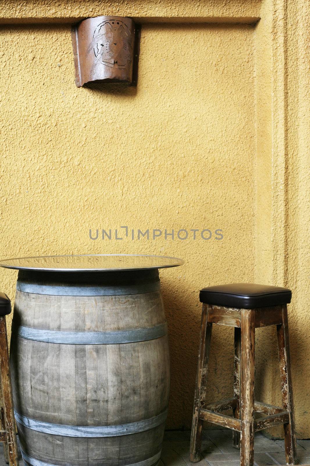 Chair and table in a pub and a background of an orange wall