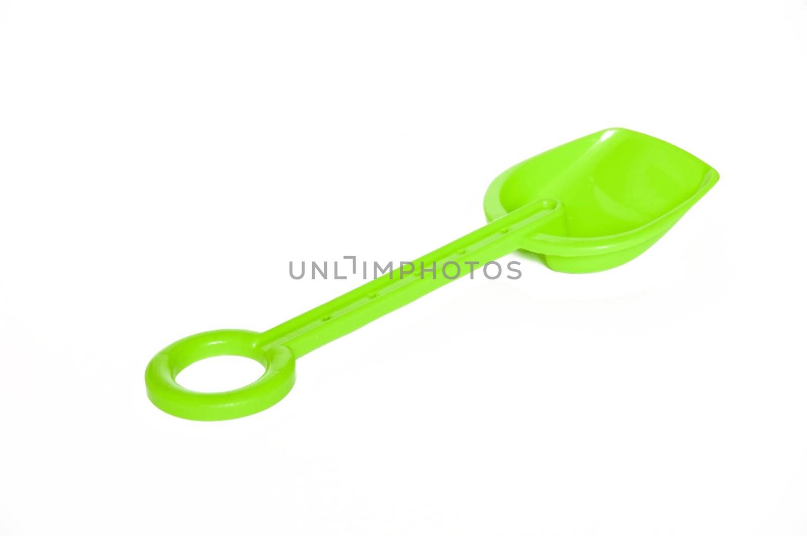 Children's green shovel on a white background
