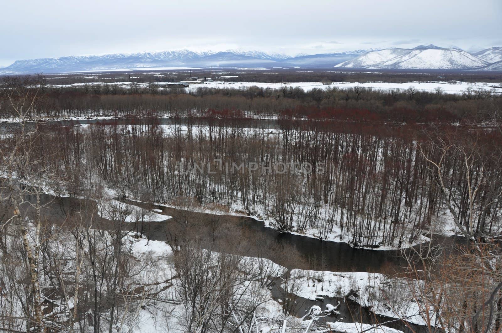 Winter landscape kamchatka with the river and hills