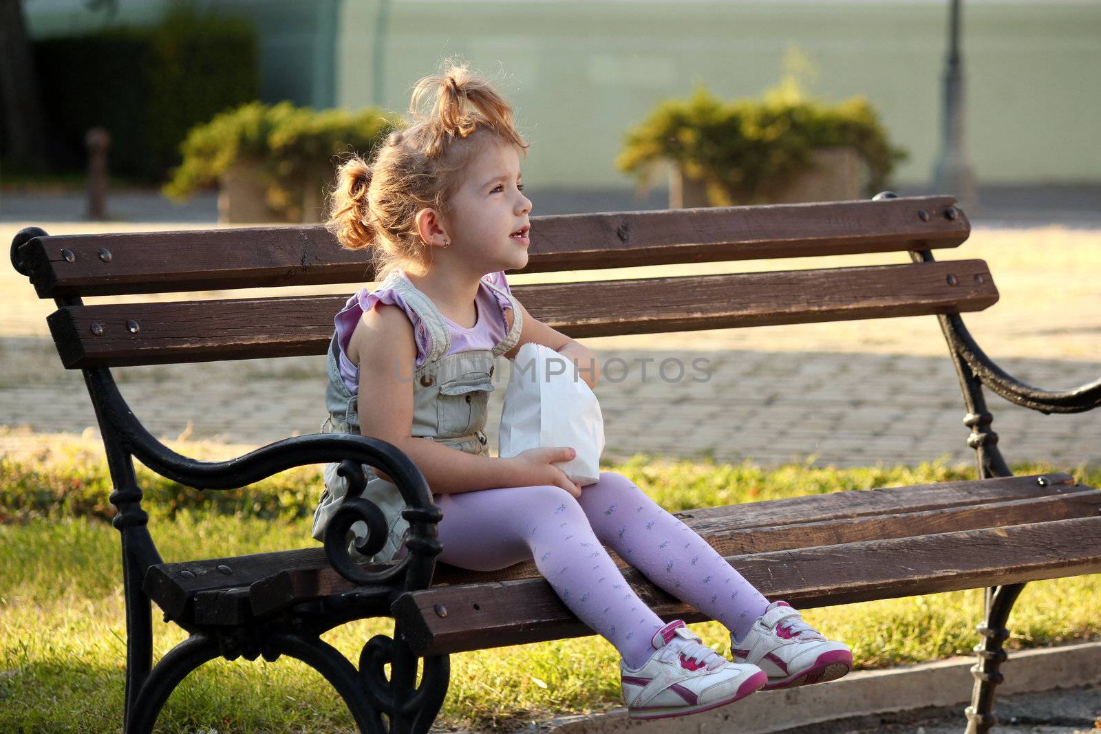 little girl sitting on the bench by goce