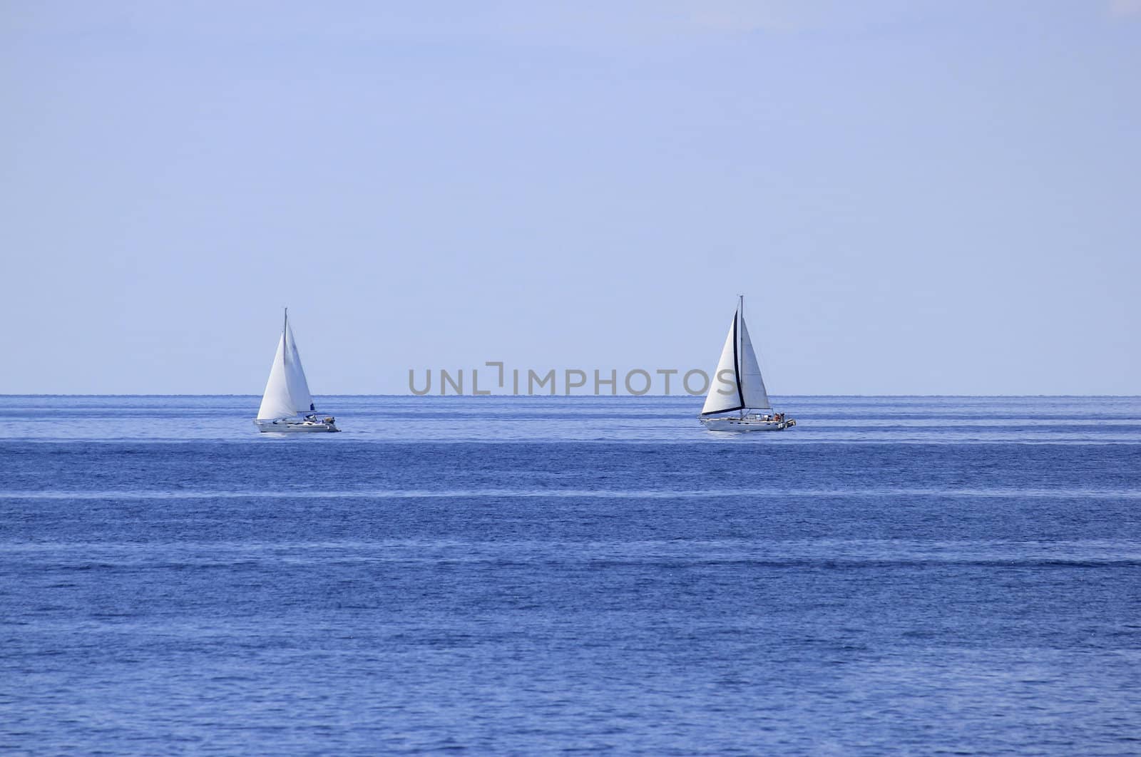 Two sailboats on open sea horizon by xbrchx