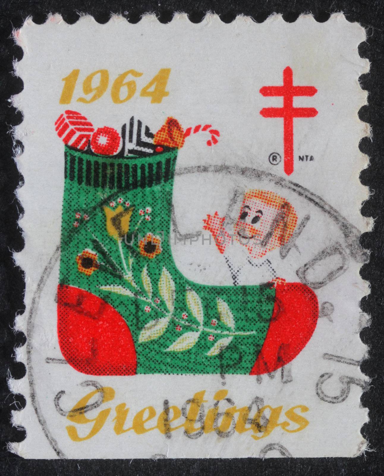 UNITED STATES OF AMERICA - CIRCA 1964: A greeting Christmas stamp printed in the USA shows a stocking with gifts