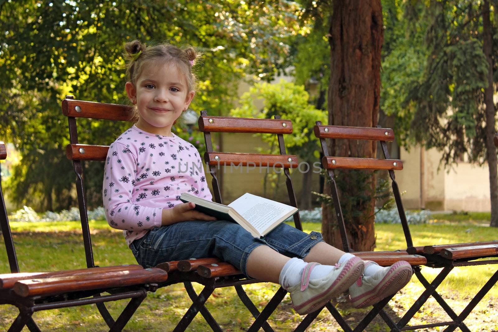 little girl with book by goce